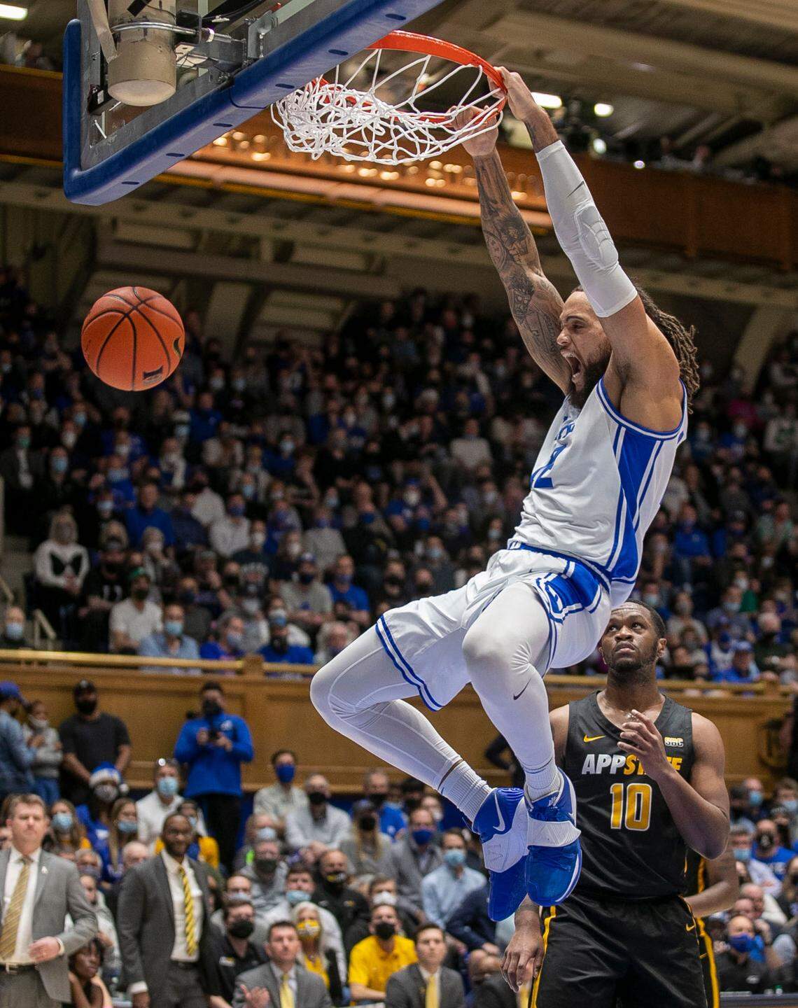 Duke’s Theo John (12) dunks over Appalachian State’s Michael Eads Jr. (10) during the first half on Wednesday, Thursday 16, 2021 at Cameron Indoor Stadium in Durham, N.C.