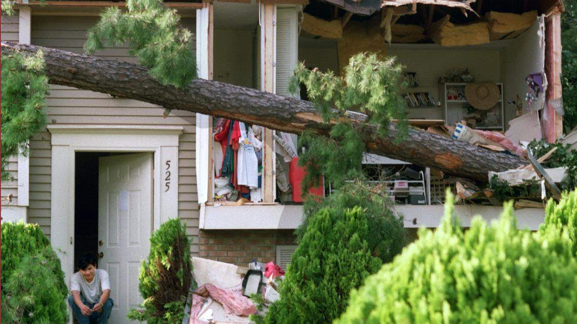 Joshua Nguyen sits in the doorway of his uncle’s Tuan Do’s home as he waits for him to come home to his wrecked house on Drolmond Rd. in North Raleigh. The storm tracked more than 200 miles inland in September 1996 and left many in Raleigh without power for more than a week.