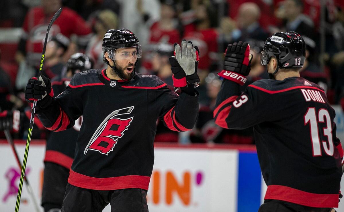 Carolina Hurricanes’s Vincent Trocheck (16) high fives teammate Max Domi (13) after a goal by Tuevo Teravainen (86) during the first period on Saturday, May 14, 2022 during game seven of the Stanley Cup first round at PNC Arena in Raleigh, N.C.