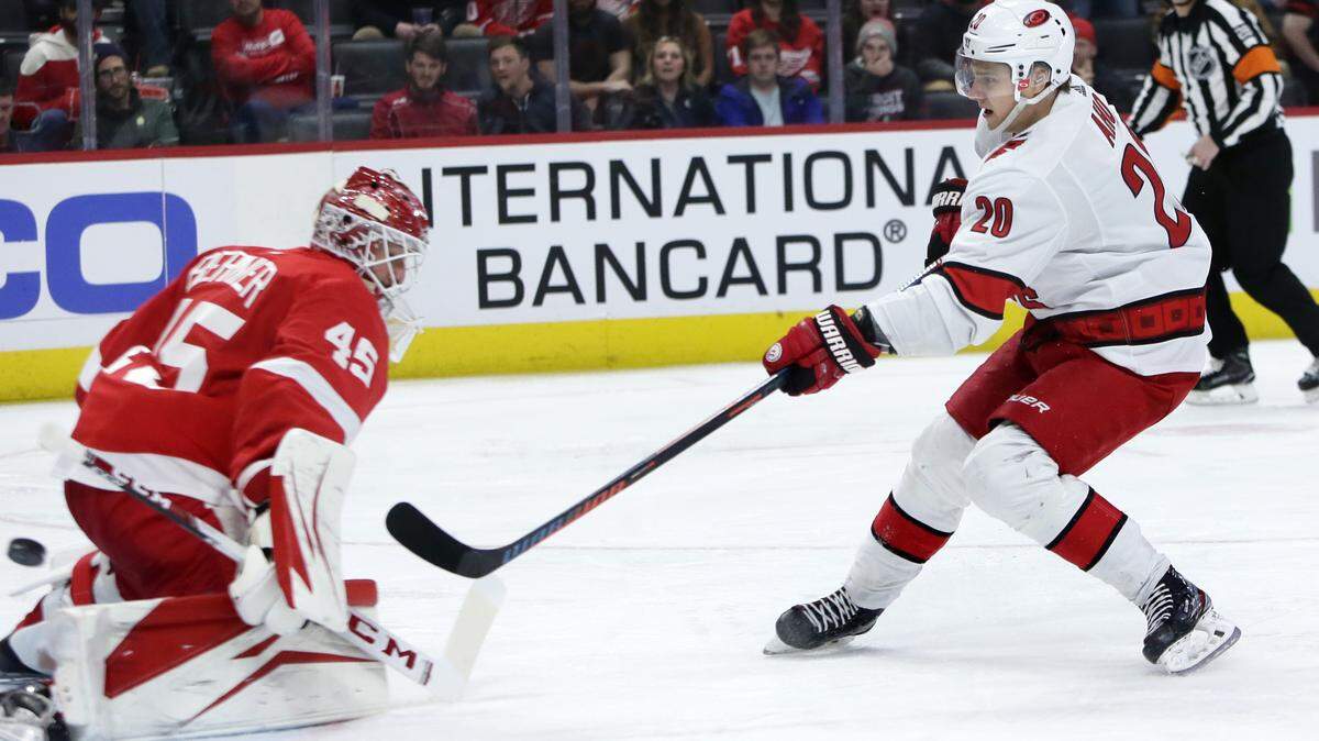 Carolina Hurricanes center Sebastian Aho (20) scores on Detroit Red Wings goaltender Jonathan Bernier (45) in the Canes’ last game before the NHL pause on March 10, 2020, in Detroit. (AP Photo/Duane Burleson)