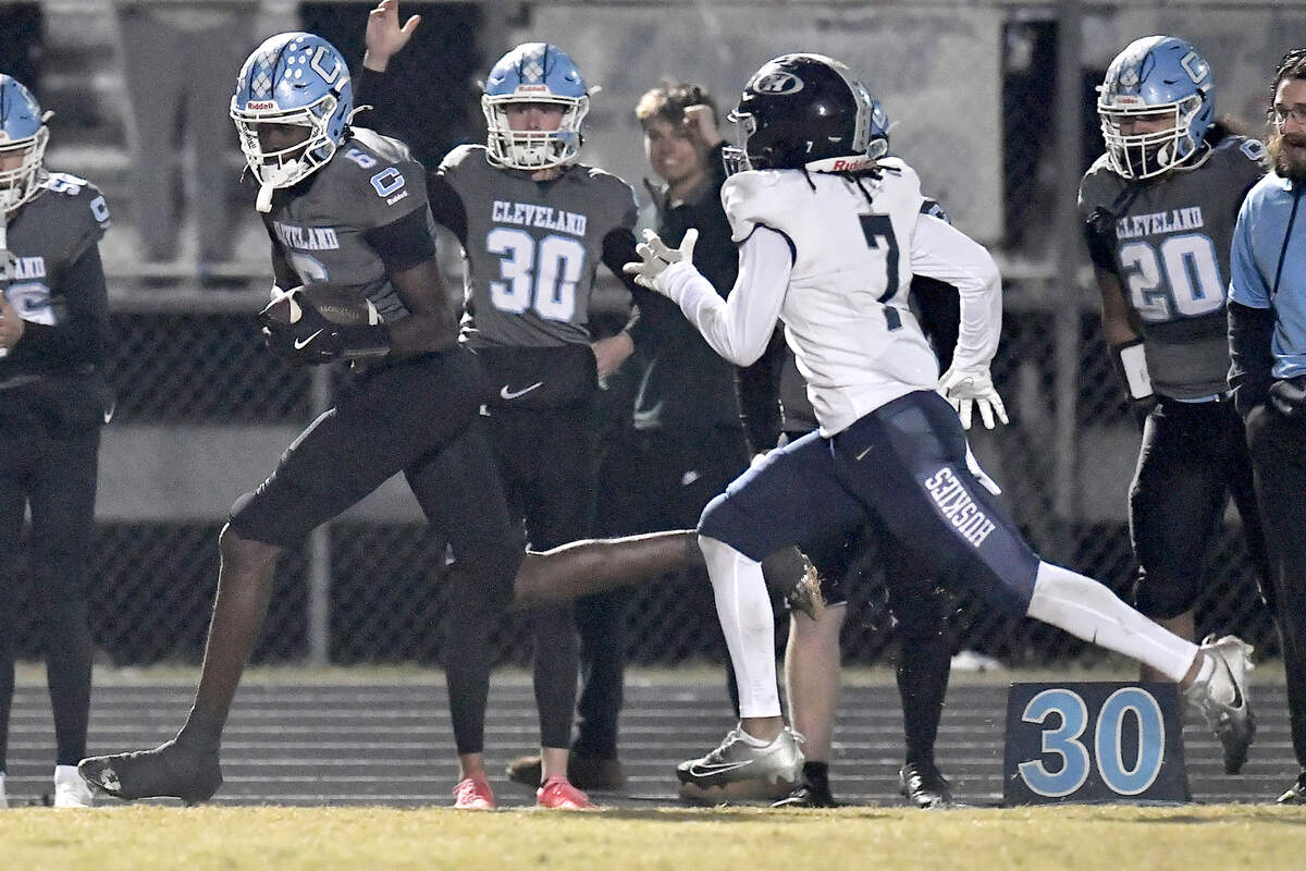 Cleveland wide receiver Malachi Thomas (6) runs along the sidelines for the first down ahead of Heritage’s Sean Allen (7) late in the second half. The Cleveland Rams and the Heritage Huskies met in the first round of the NCHSAA 4A playoffs in Clayton, N.C. on November 15, 2024.
