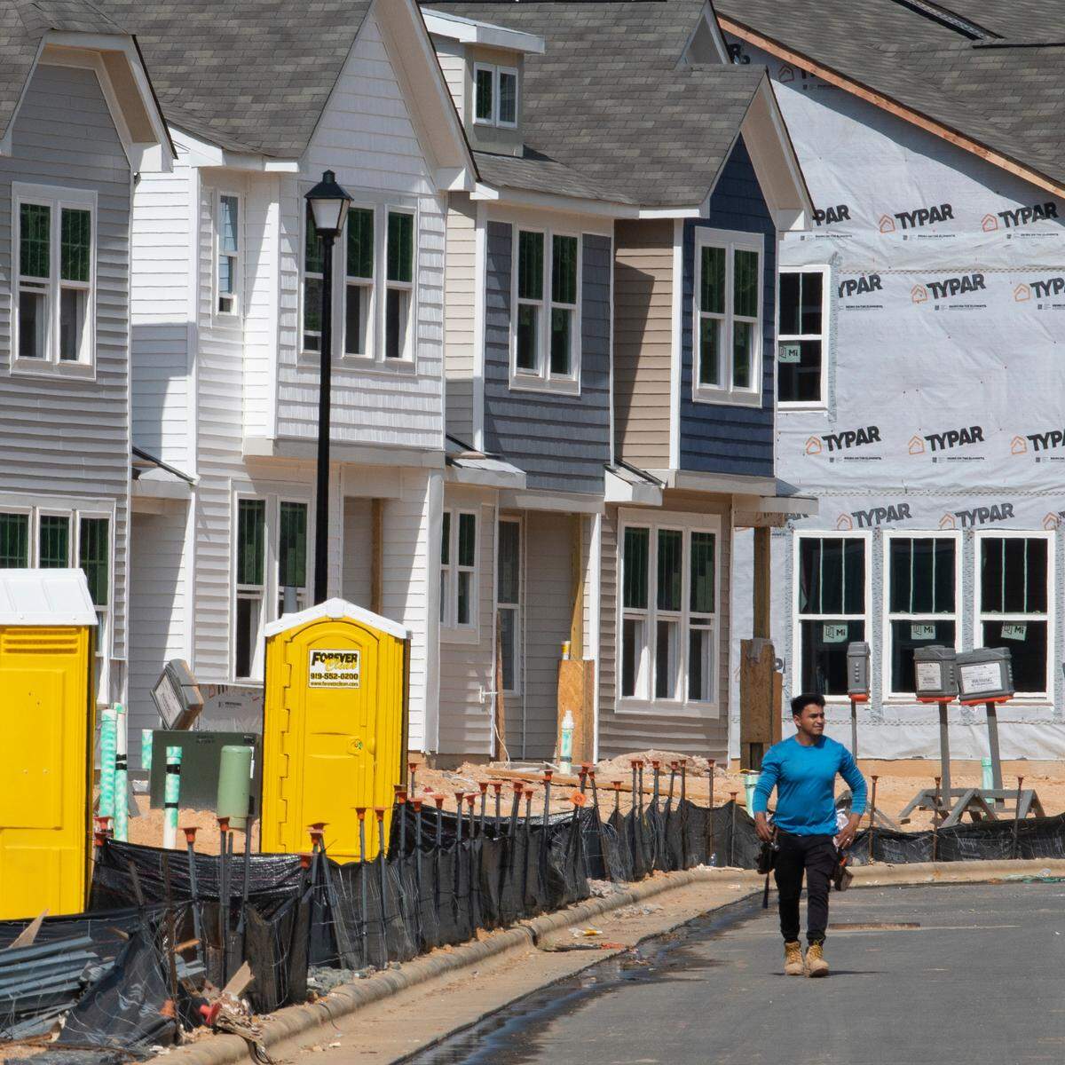 A worker arrives at a construction site for new townhomes in Clayton, N.C., Thursday, Sept. 22, 2022. This area of Johnston County has seen rapid growth over the past decade.