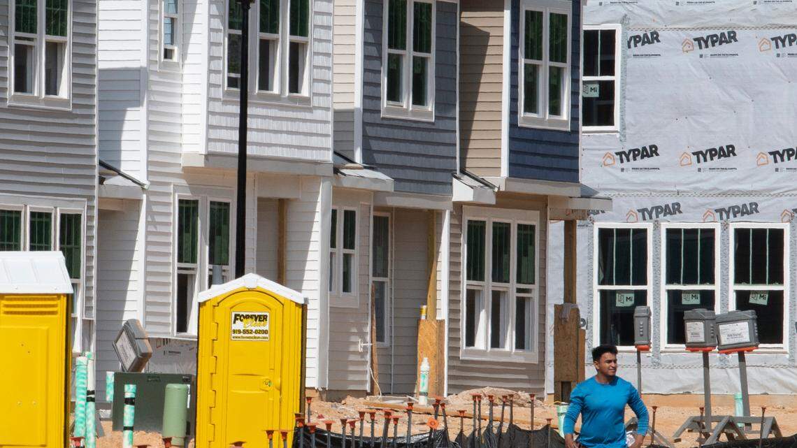 A worker arrives at a construction site for new townhomes in Clayton, N.C., Thursday, Sept. 22, 2022. This area of Johnston County has seen rapid growth over the past decade.