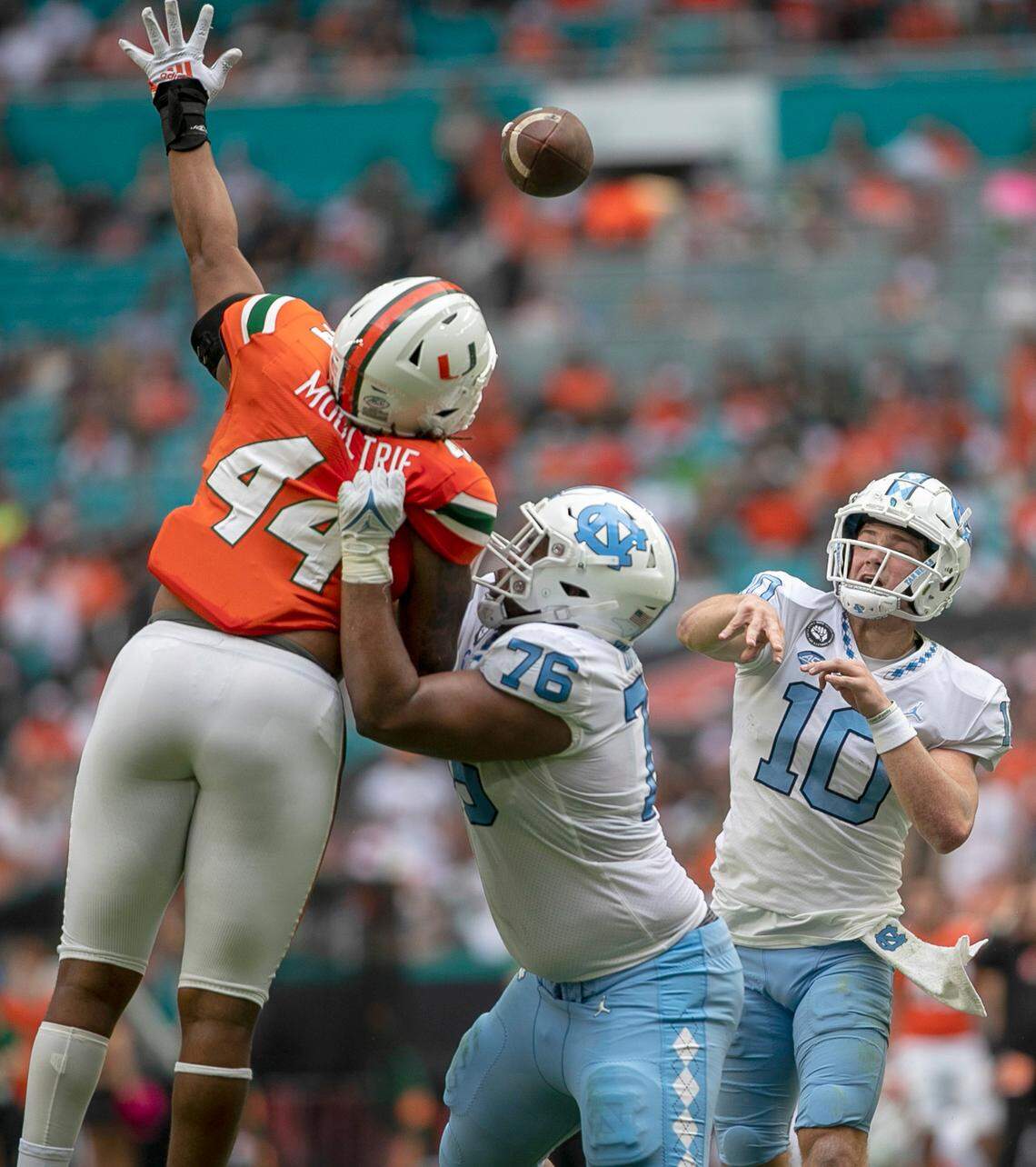 Miami defensive lineman Antonio Moultrie (44) pressure North Carolina quarterback Drake Maye (10) in the second quarter on Saturday, October 8, 2022 at Hard Rock Stadium in Miami Gardens, Florida.