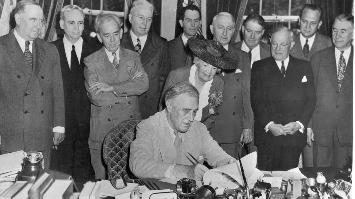 Franklin D. Roosevelt signing the Servicemen’s Readjustment Act (GI Bill) into law, June 1944.