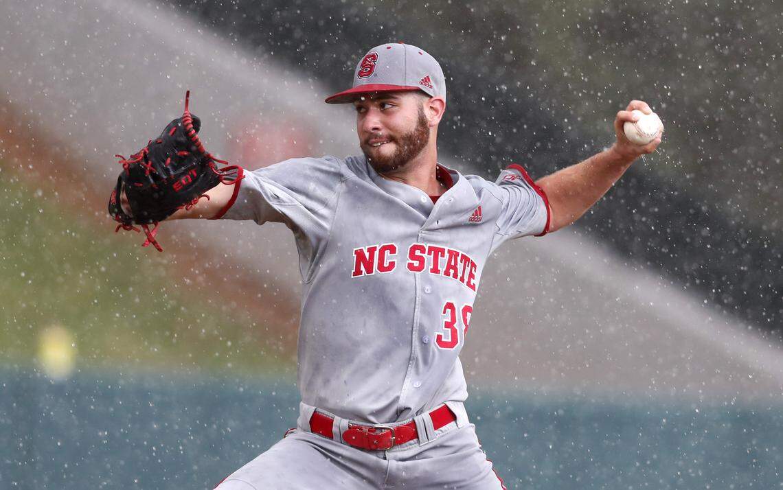 N.C. State pitcher Brian Brown (38) throws in the rain in the ninth inning during the Wolfpack's 9-3 victory over Northeastern in the Raleigh Regional Saturday, June 2, 2018.