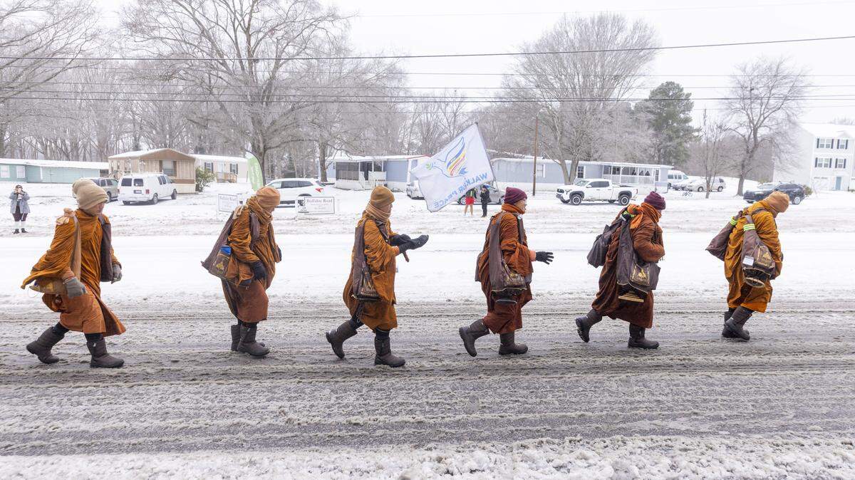 Despite winter weather conditions, a procession of Buddhist monks walks along Buffaloe Road on Sunday, Jan. 25, 2026, in Raleigh. The monks are making a 2,300-mile pilgrimage from Texas to Washington, D.C., as part of the Walk for Peace, an effort to promote peace, compassion and national unity.
