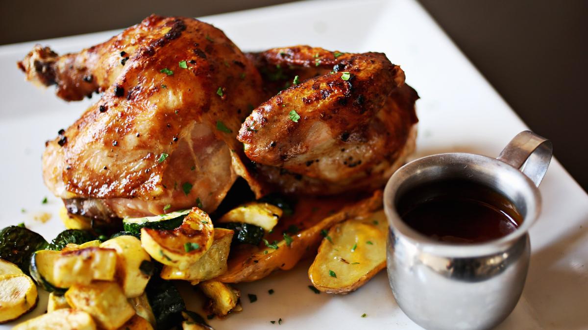 Jaime's BBQ 1/2 Chicken is a house-smoked and wood fire oven-roasted, served with Jaime's Bourbon BBQ sauce, seasonal veggies and potatoes at It's a Southern Thing in Durham.