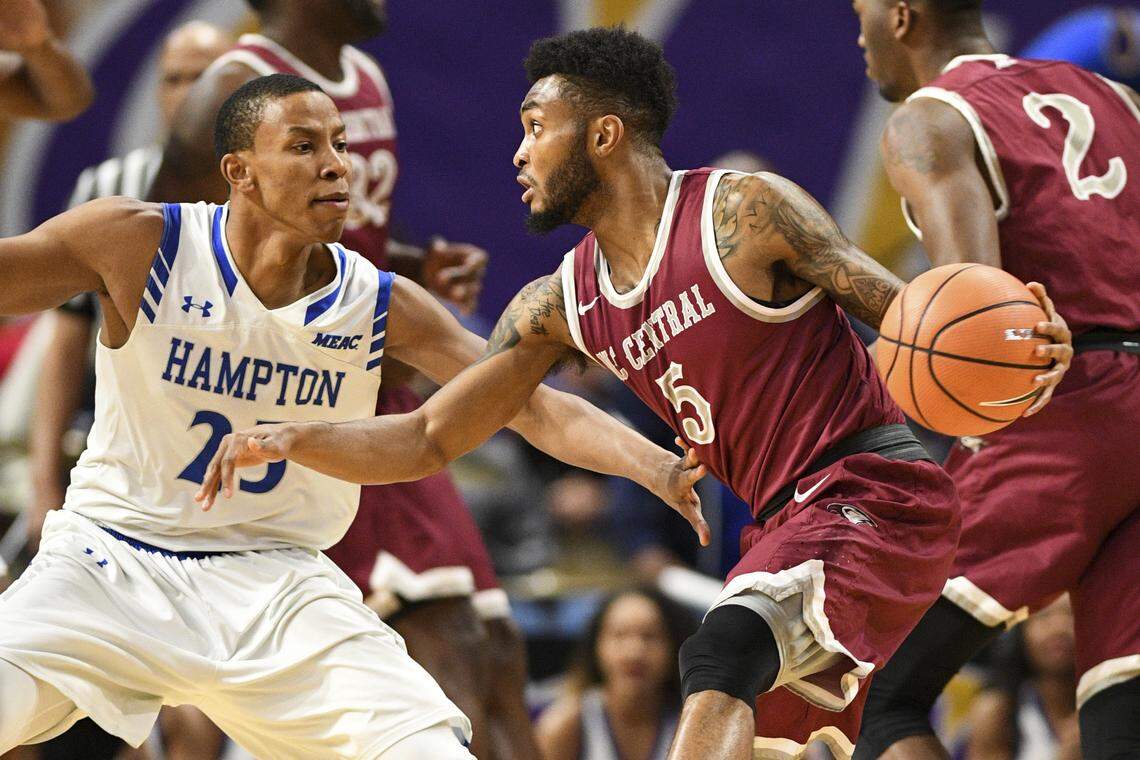 NC Central guard Reginald Gardner Jr. , dribbles against Hampton guard Akim Mitchell during the finals of the Mid-Eastern Athletic Conference tournament, Saturday, March 10, 2018, in Norfolk, Va.