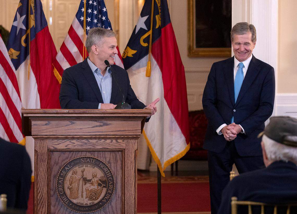 Incoming Gov. Josh Stein acknowledges Gov. Roy Cooper during remarks at a ceremony to award The Order of the Long Leaf Pine to former North Carolina basketball coach Roy Williams at the Executive Mansion on Thursday, Dec. 19, 2024, in Raleigh, N.C.