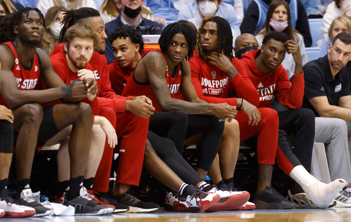 N.C. State’s Dereon Seabron (1), center, watches from the bench in the second half during UNC’s 100-80 victory over N.C. State at the Smith Center in Chapel Hill, N.C., Saturday, Jan. 29, 2022.