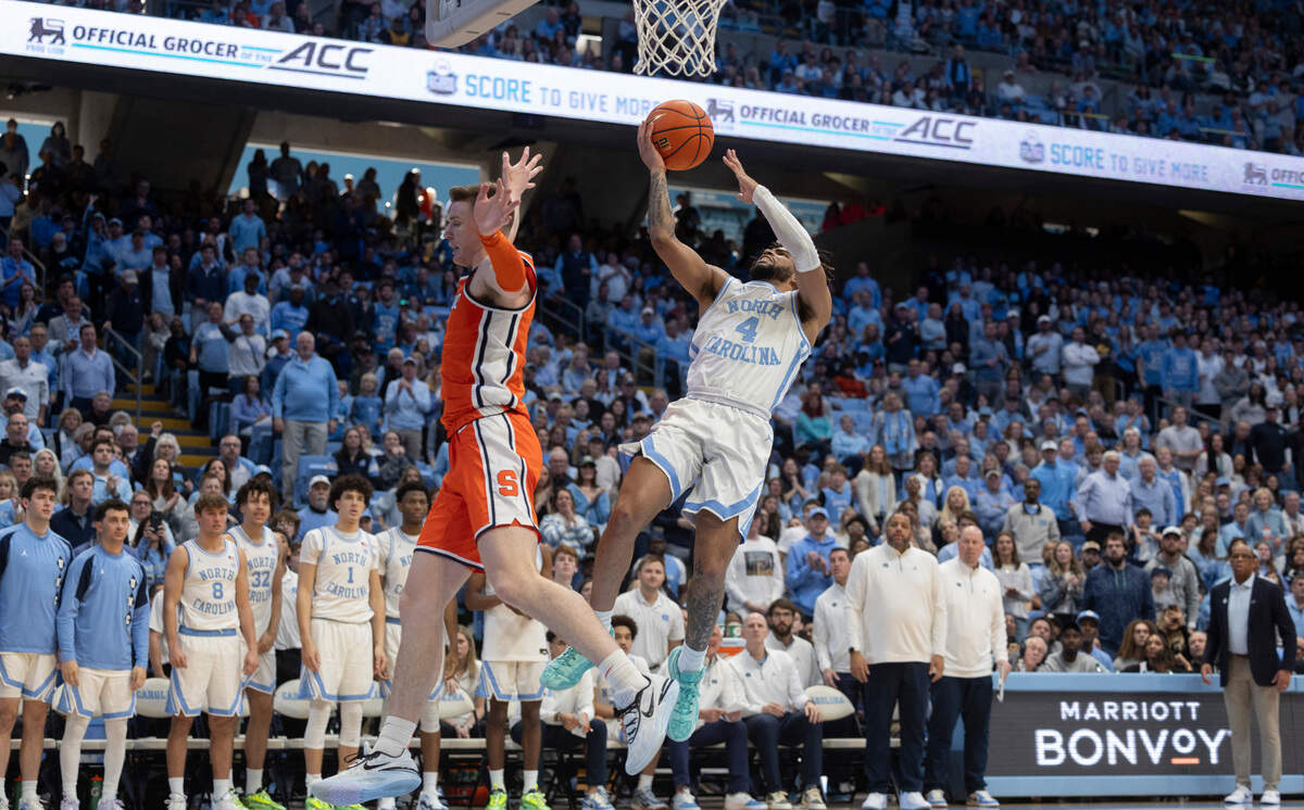 North Carolina’s R.J. Davis (4) drives to the basket against Syracuse’s Justin Taylor (5) in the second half on Saturday, January 13, 204 at the Smith Center in Chapel Hill, N.C.