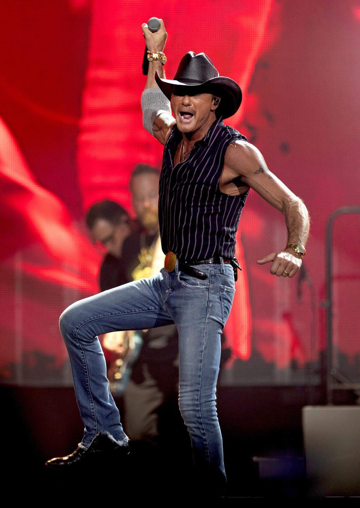 Tim McGraw, wearing pinstripes instead of a white t-shirt with a barbecue stain, works the PNC Arena crowd in Raleigh, Saturday night, June 22, 2024.