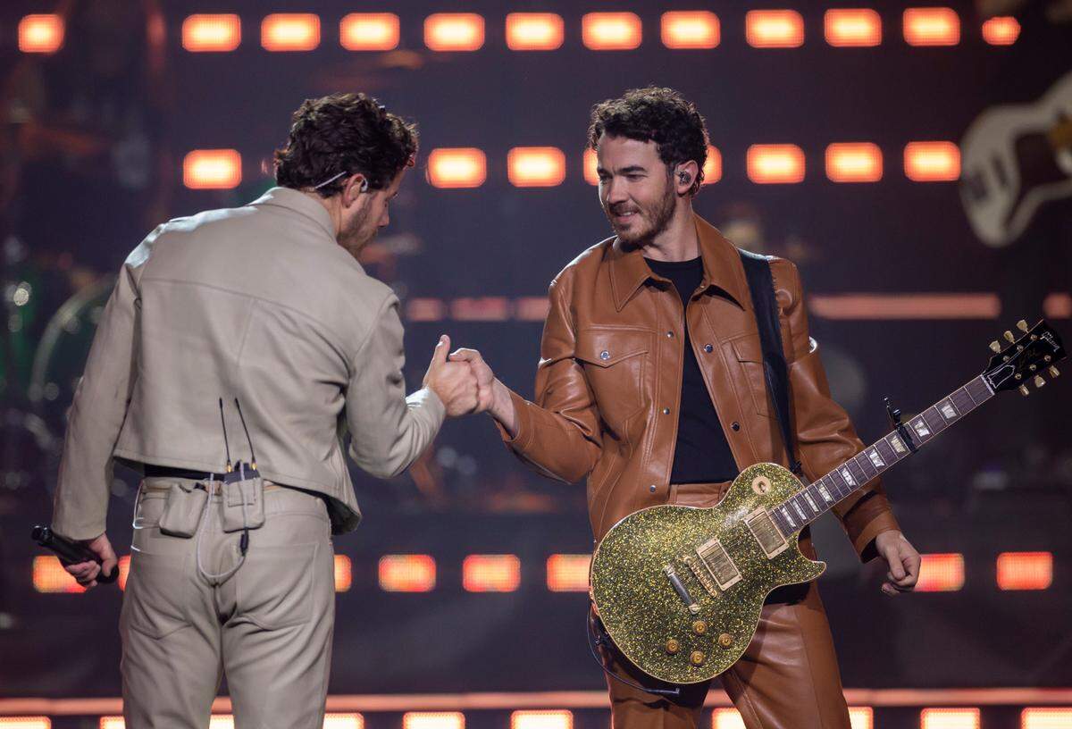 Nick and Kevin Jonas greet each other as they take the stage during their “Five Albums, One Night” tour stop at the PNC Arena on Thursday, September 28, 2023 in Raleigh, N.C.