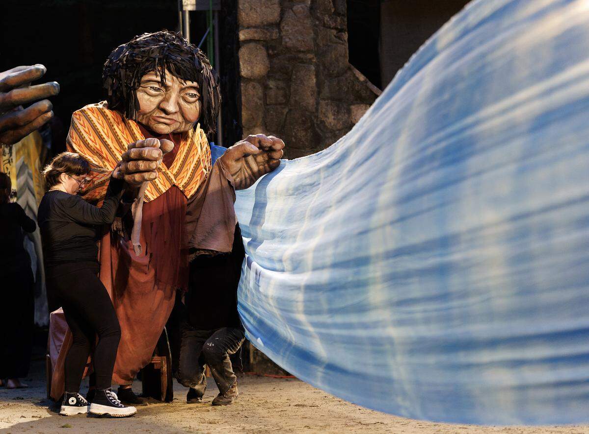 Puppeteers with Paperhand Puppet Intervention work together to bring a giant puppet to life during rehearsal for “The Gift” at the Forest Theatre on Tuesday, Aug. 12, 2025, in Chapel Hill, N.C.