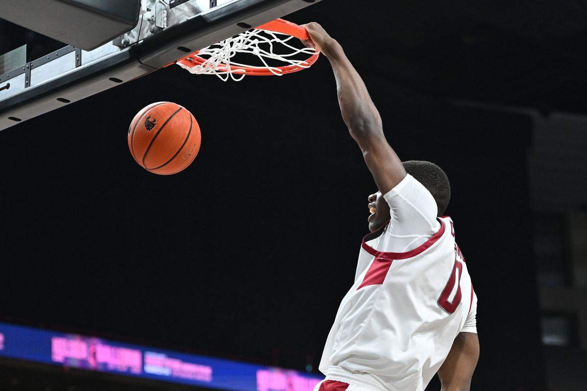Nov 21, 2024; Spokane, Washington, USA; Washington State Cougars guard Cedric Coward (0) dunks the ball against the Eastern Washington Eagles in the second half at Spokane Veterans Memorial Arena. Washington State Cougars won 96-81.