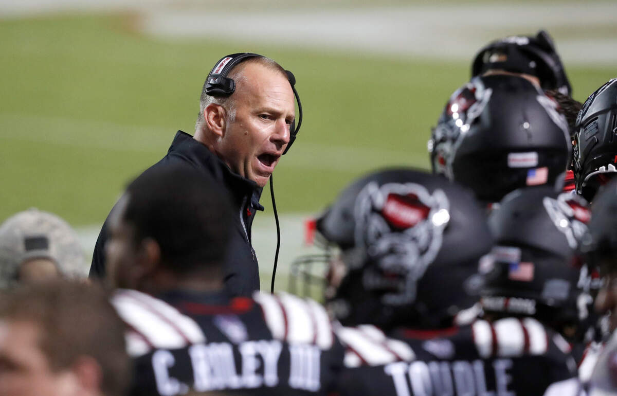 N.C. State head coach Dave Doeren encourages his team during the second half of Miami’s 44-41 victory over N.C. State at Carter-Finley Stadium in Raleigh, N.C., Friday, Nov. 6, 2020.