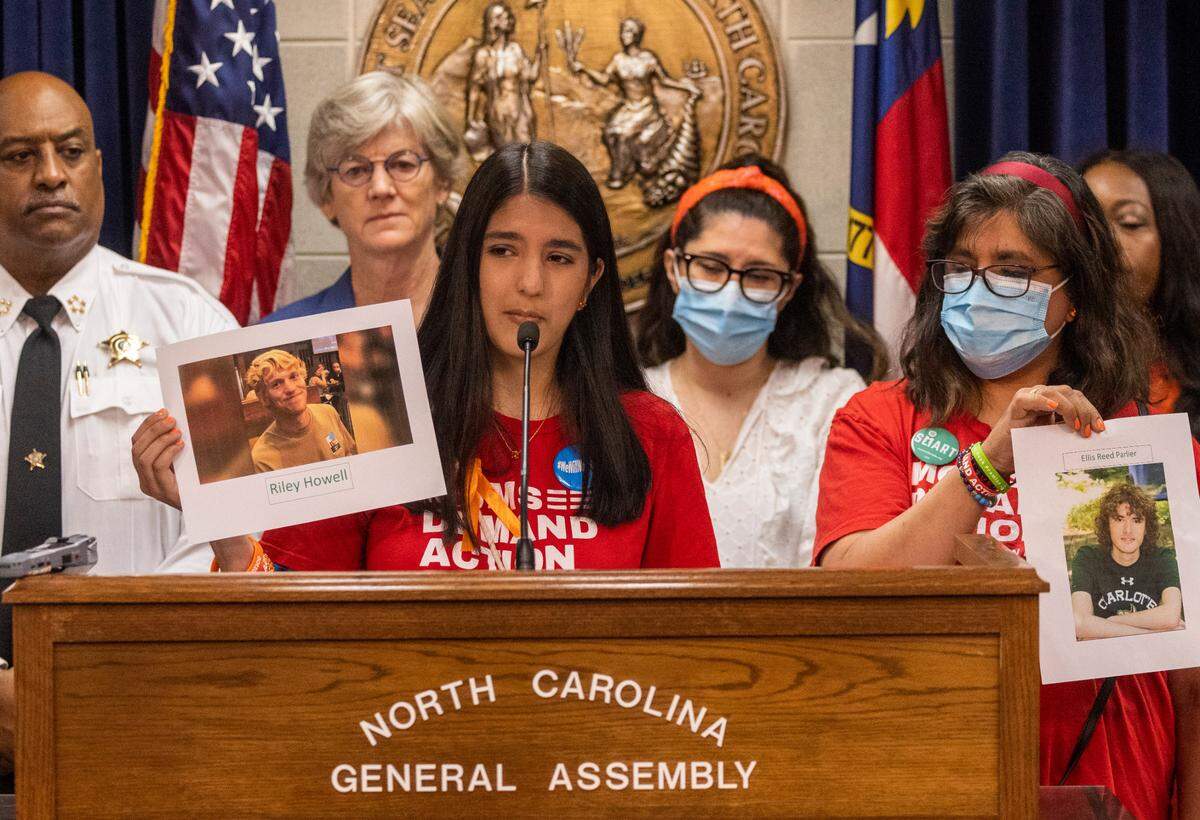 Leah Krevat of Students Demand Action holds a photograph of Riley Howell and her mother Madhavi Krevat holds a photo of Reed Parlier during a press conference demanding gun legislation at the General Assembly Thursday, June 9, 2022 after the mass shooting at Robb Elementary School in Uvalde, Texas. Howell and Parlier were killed by a gunman on the campus at UNC Charlotte in 2019.