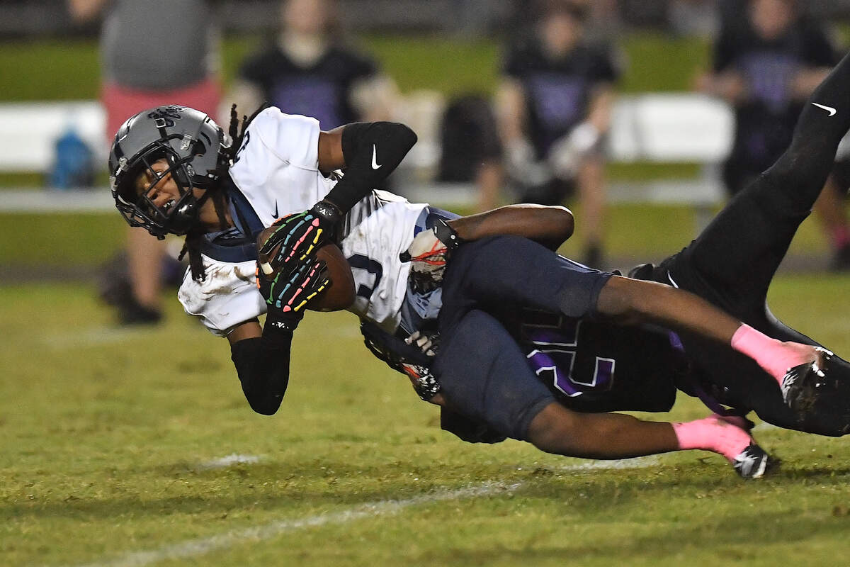 Hillside’s Erick Bonner (3) is tackled by Riverside’s Darryn Johnson (24) off the punt return during the first half. The Durham Hillside Hornets and the Durham-Riverside Pirates met in a football game in Durham. N.C. on October 4, 2024.