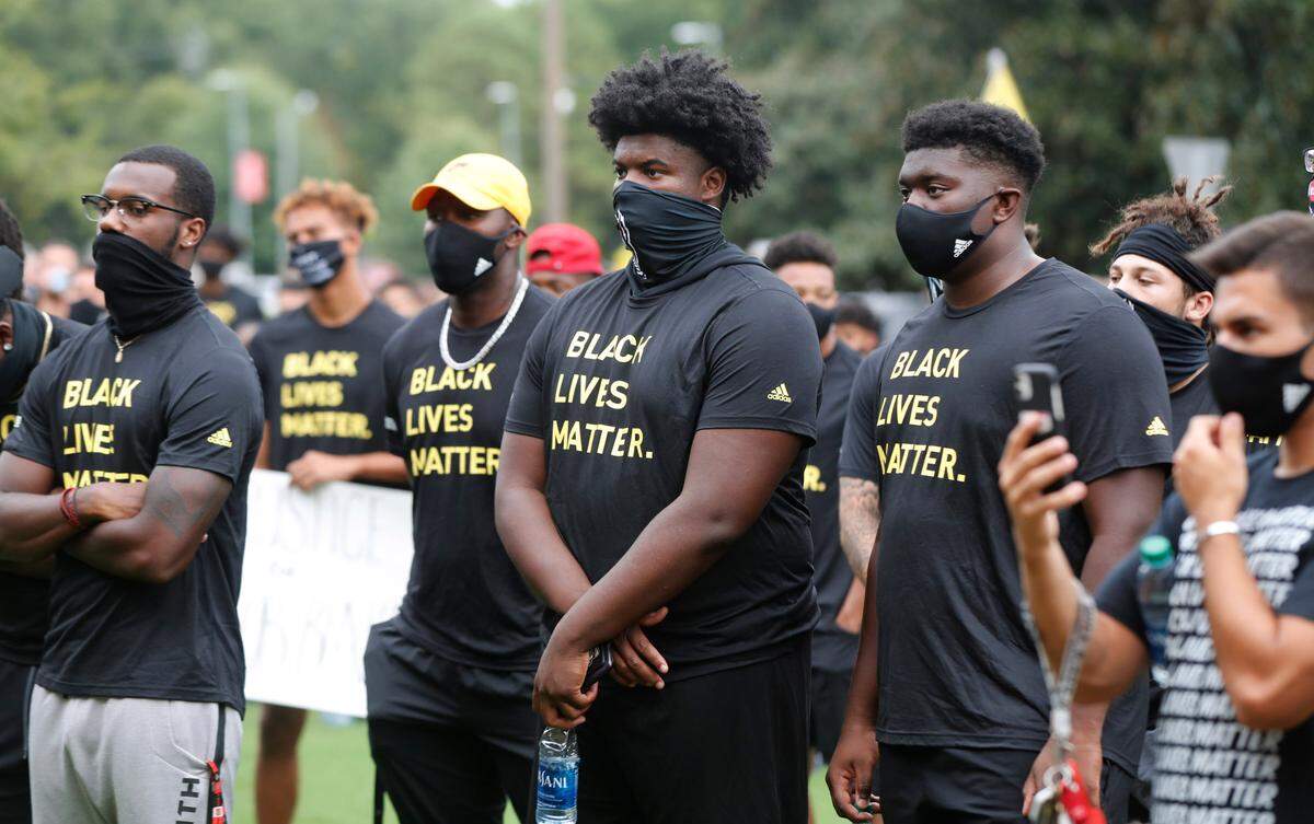 N.C. State athletes, coaches and staff listen to the speakers during a #PackUnited peaceful protest against racial and social injustice outside Holladay Hall on the campus of N.C. State Saturday, Sept. 12, 2020.