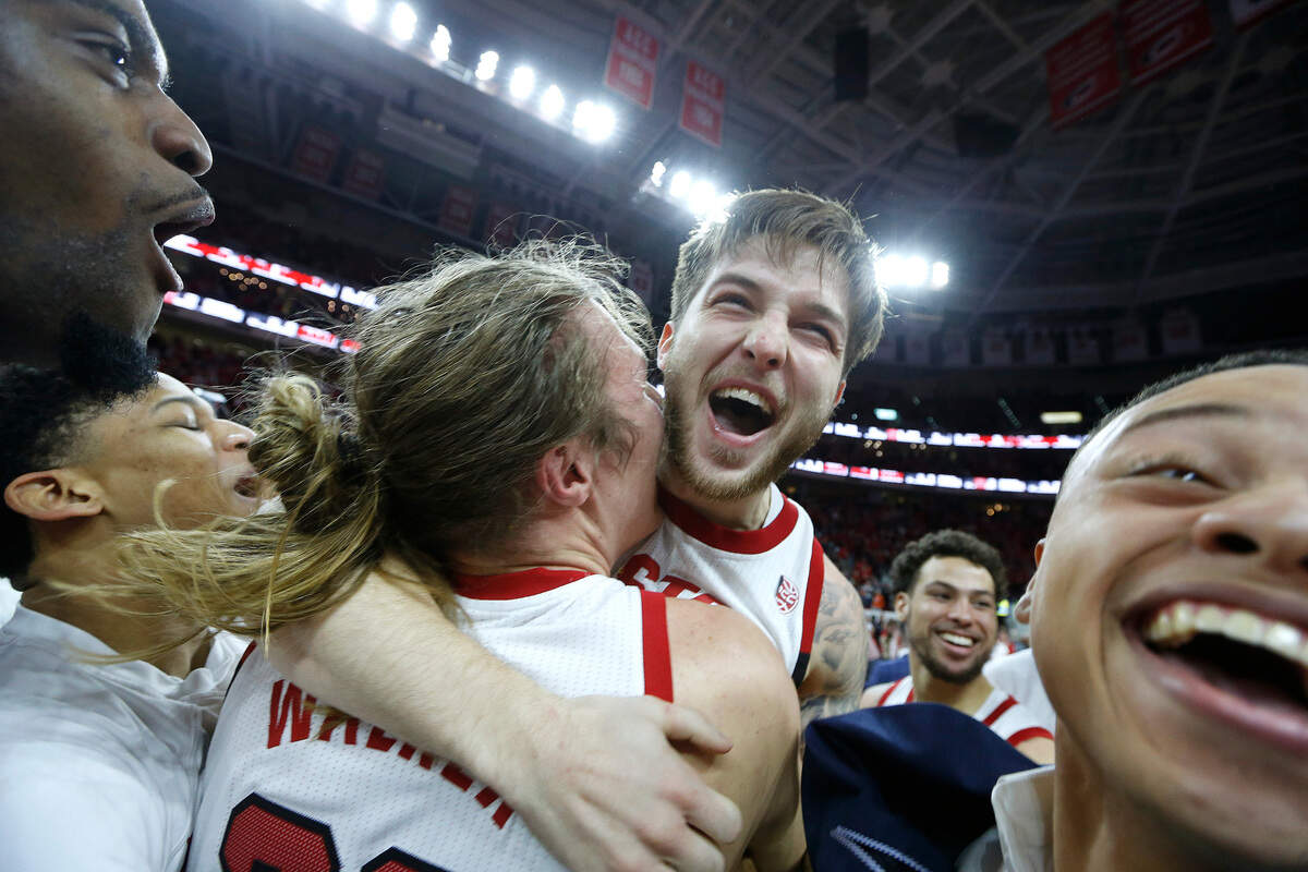 N.C. State’s Braxton Beverly (10) celebrates with Wyatt Walker (33) after scoring the game winner during the second half of N.C. State’s 69-67 victory over Clemson at PNC Arena in Raleigh, N.C., Saturday, January 26, 2019.