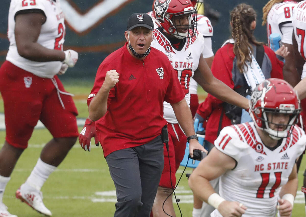 N.C. State head coach Dave Doeren celebrates during the first half of N.C. State’s game against Virginia at Scott Stadium in Charlottesville, Va., Saturday, Oct. 10, 2020.