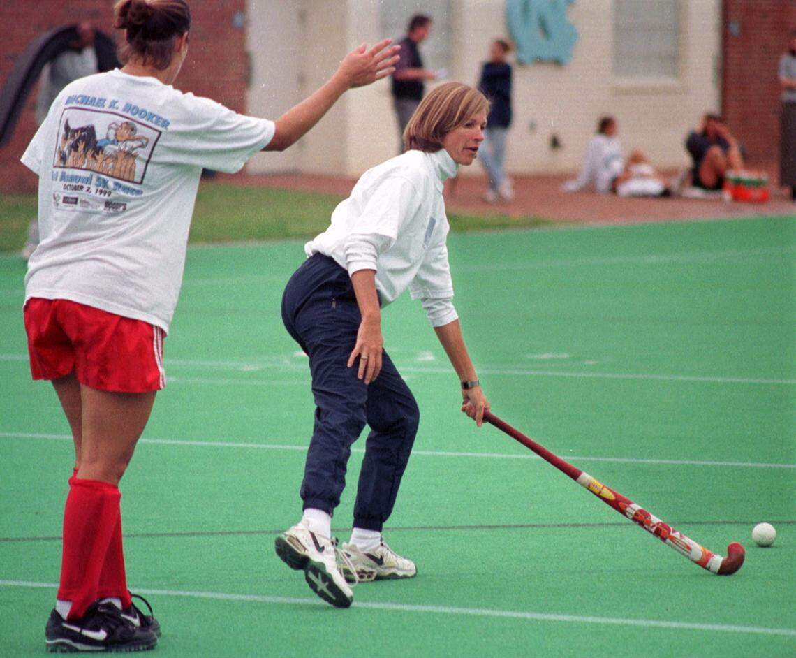 UNC-CH womens’ field hockey head coach Karen Shelton takes stick in hand to show some of her players how to make a move during team practice in 1999.