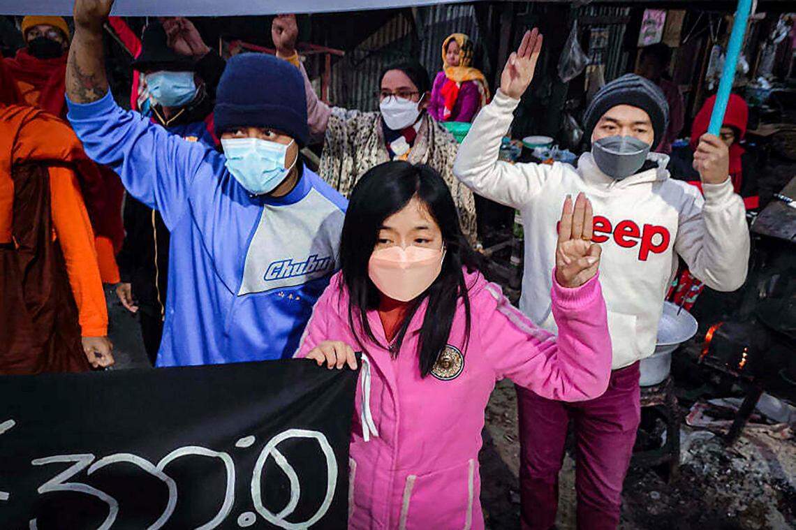 Youth activists flash the three-finger protest gesture during an anti-military government protest rally on Tuesday, Feb. 1, 2022, in Mandalay, Myanmar. The new U.N. special envoy for Myanmar says violence has intensified since the military took power a year ago and sparked a resistance movement in the country. (AP Photo)