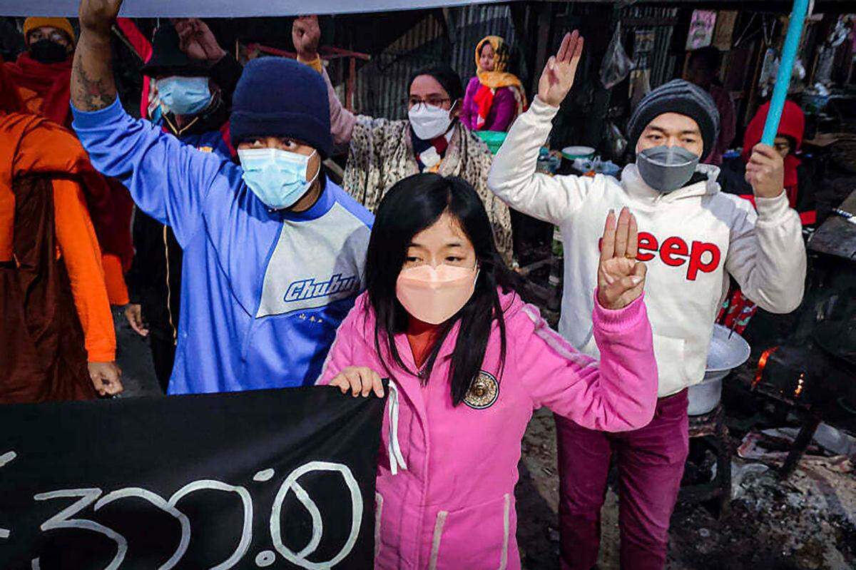 Youth activists flash the three-finger protest gesture during an anti-military government protest rally on Tuesday, Feb. 1, 2022, in Mandalay, Myanmar. The new U.N. special envoy for Myanmar says violence has intensified since the military took power a year ago and sparked a resistance movement in the country. (AP Photo)