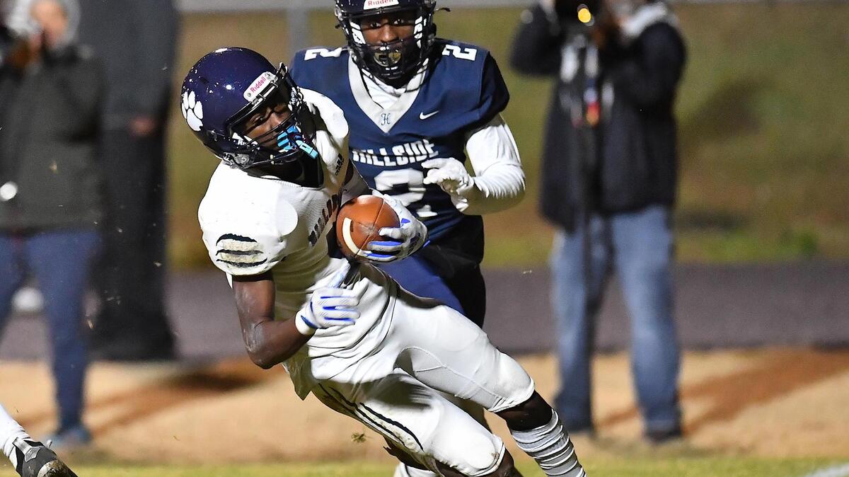 Millbrook’s Session McArthur (5) makes the interception against Hillside’s Tahir Henry (2) in the first half. The Hillside Hornets and the Millbrook Wildcats met in the NCHSAA 4a fourth round playoff game in Durham, NC, on November 25, 2022.
