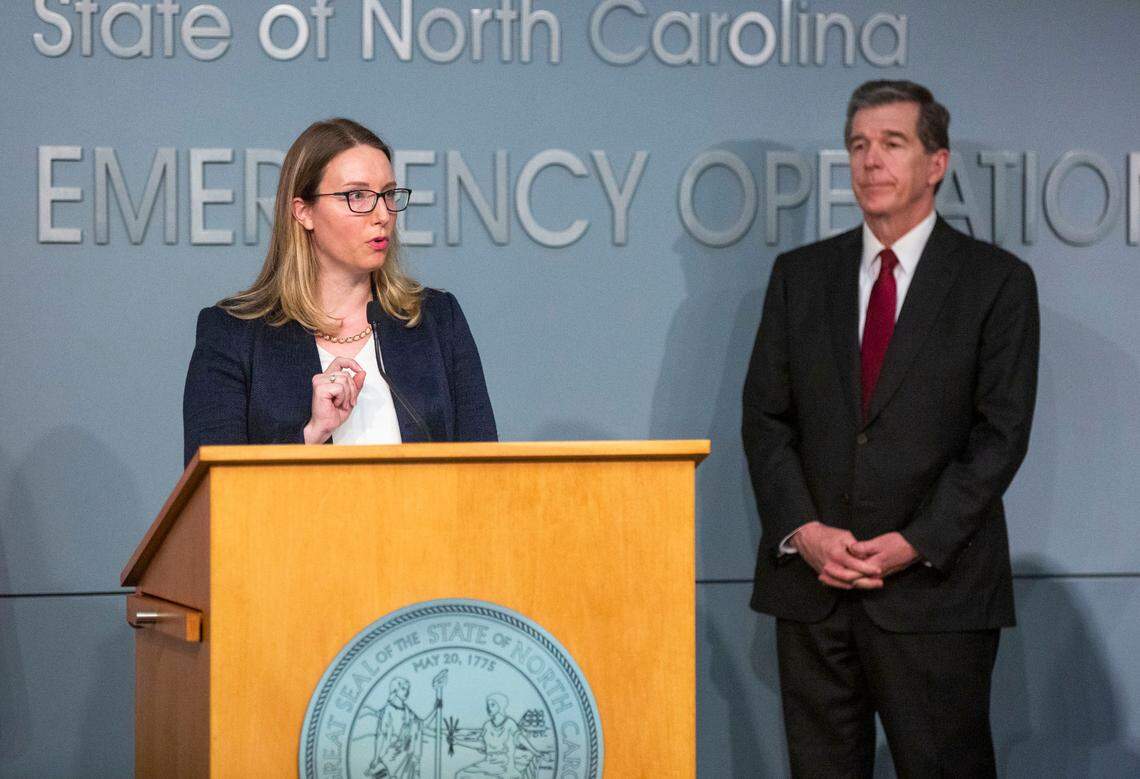 Gov. Roy Cooper listens as Laura Hogshead, the chief operating officer of the North Carolina Office of Recovery and Resiliency, speaks about the adaptation of hurricane recovery efforts during the coronavirus pandemic during a briefing Monday, Jun. 15, 2020, at the N.C. Emergency Operations Center in Raleigh, N.C.