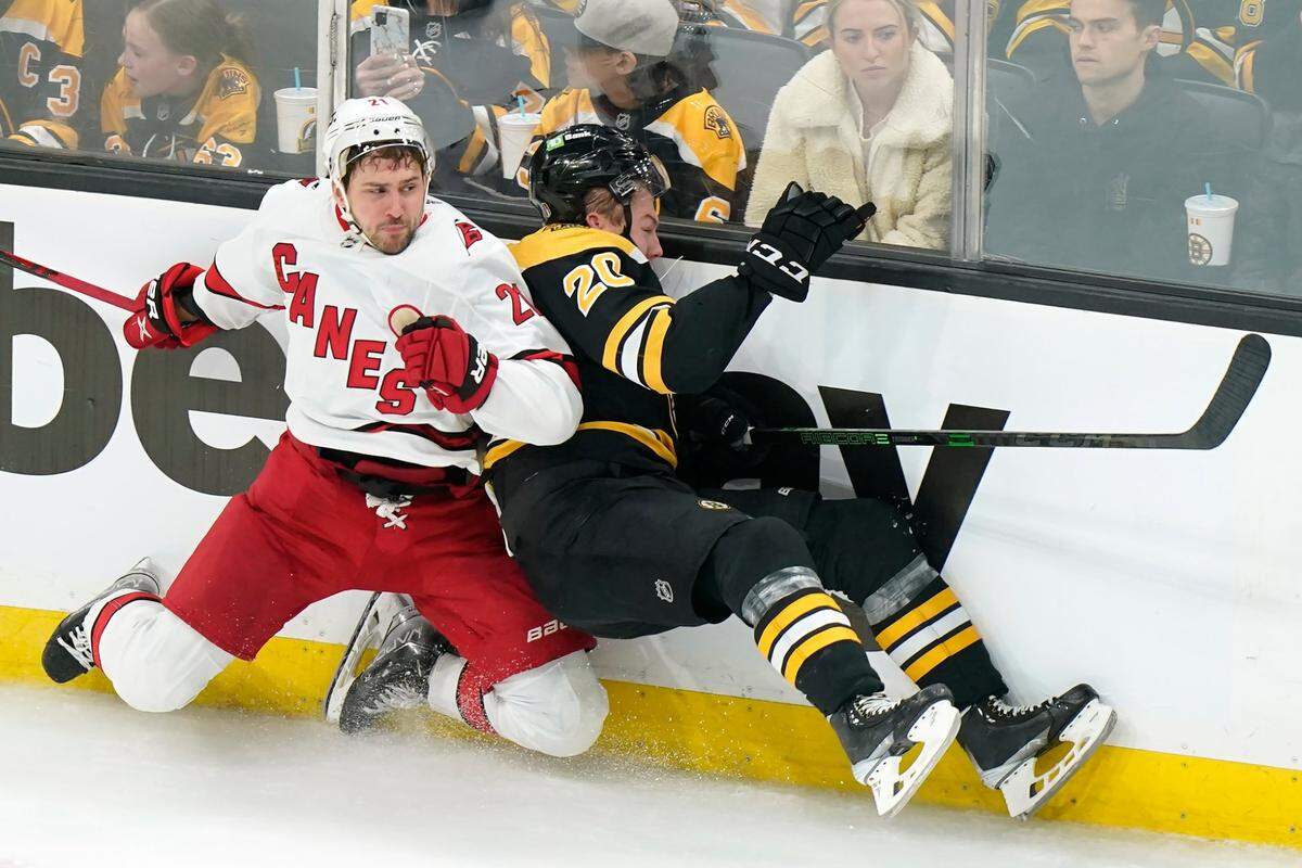 Carolina Hurricanes’ Nino Niederreiter, of Switzerland, left, slams Boston Bruins’ Curtis Lazar, right, into the boards in the third period of Game 4 of an NHL hockey Stanley Cup first-round playoff series, Sunday, May 8, 2022, in Boston. The Bruins won 5-2. (AP Photo/Steven Senne)