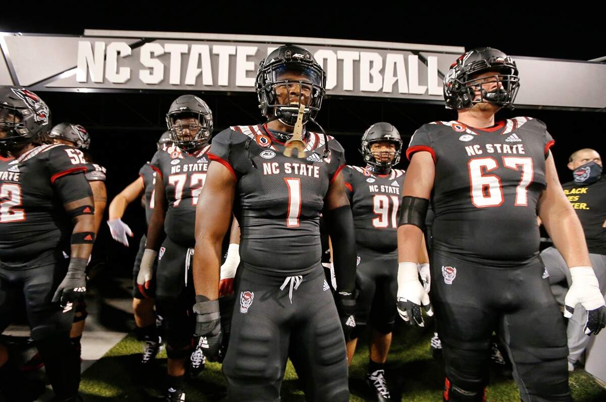 N.C. State linebacker Isaiah Moore (1) is pumped up before coming on the field to warmup before N.C. State’s game against Miami at Carter-Finley Stadium in Raleigh, N.C., Friday, Nov. 6, 2020. To the right is N.C. State offensive tackle Justin Witt (67).
