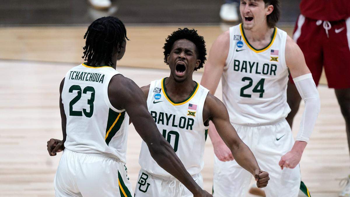 Baylor guard Adam Flagler (10), Jonathan Tchamwa Tchatchoua (23) and Matthew Mayer (24) celebrate a play against Arkansas during the second half of an Elite 8 game in the NCAA men’s college basketball tournament at Lucas Oil Stadium, Monday, March 29, 2021, in Indianapolis.
