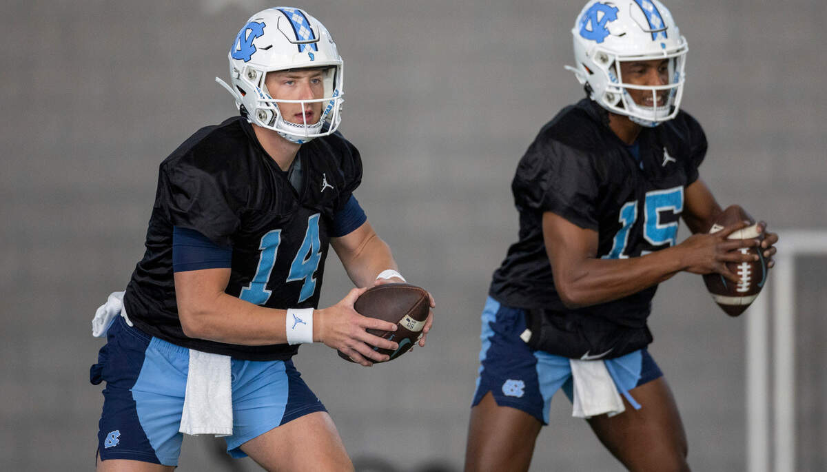 North Carolina graduate transfer quarterback Max Johnson (14) and sophomore quarterback Conner Harrell (15) work out during the Tar Heels’ opening day of spring football practice on Tuesday, March 19, 2024 in Chapel Hill, N.C.