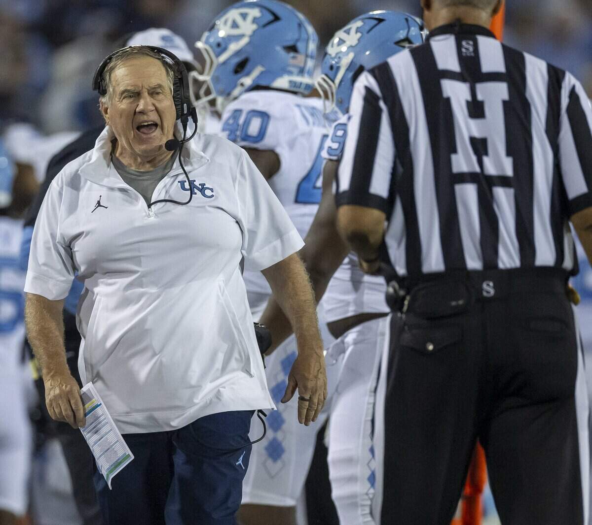 North Carolina coach Bill Belichick questions a call with official Darryl Johnson in the third quarter against UNC Charlotte on Saturday, September 6, 2025 at Jerry Richardson Stadium in Charlotte, N.C.