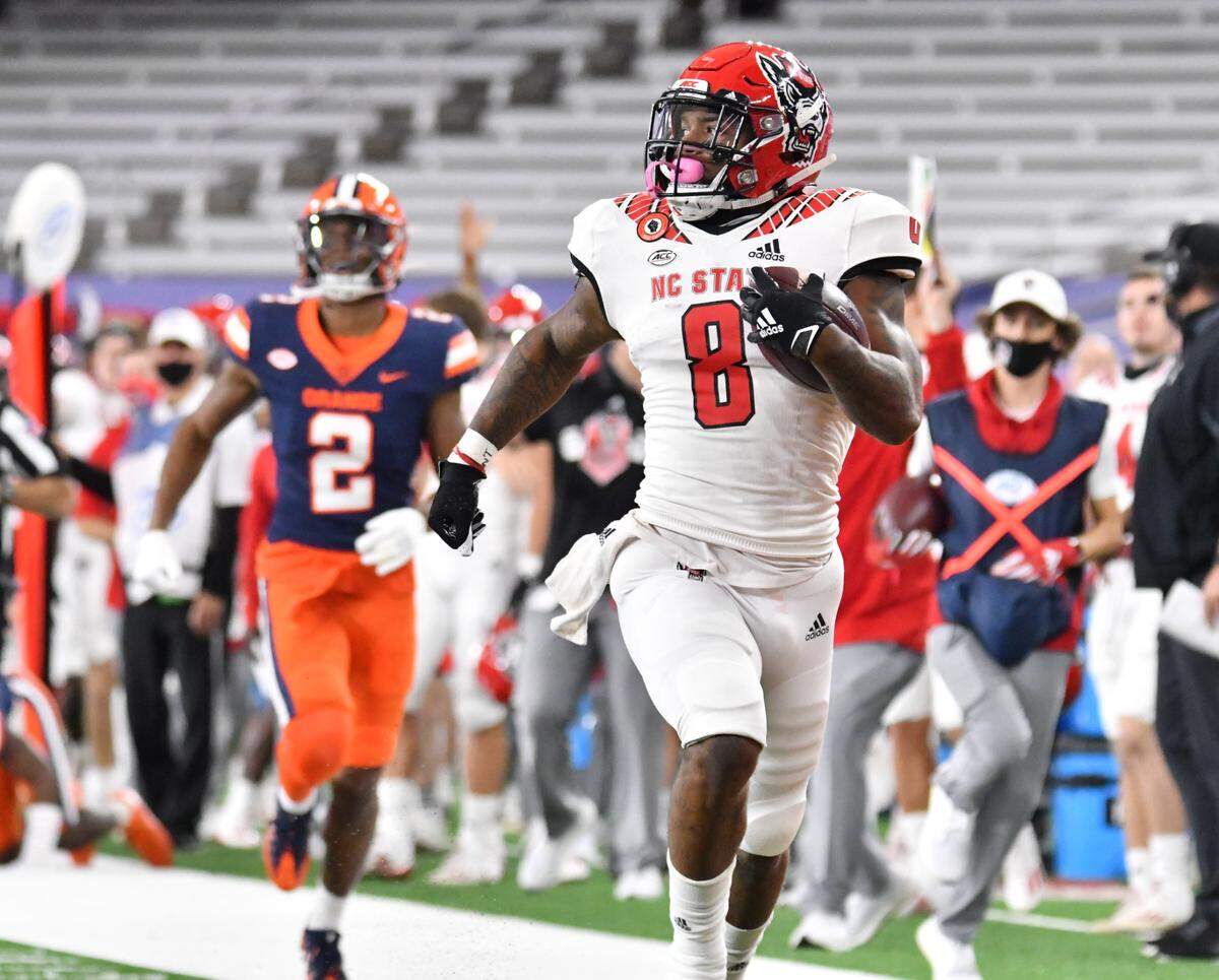 North Carolina State Wolfpack running back Ricky Person Jr. (8) runs after making a catch as Syracuse Orange defensive back Ifeatu Melifonwu (2) pursues in the first quarter at the Carrier Dome.