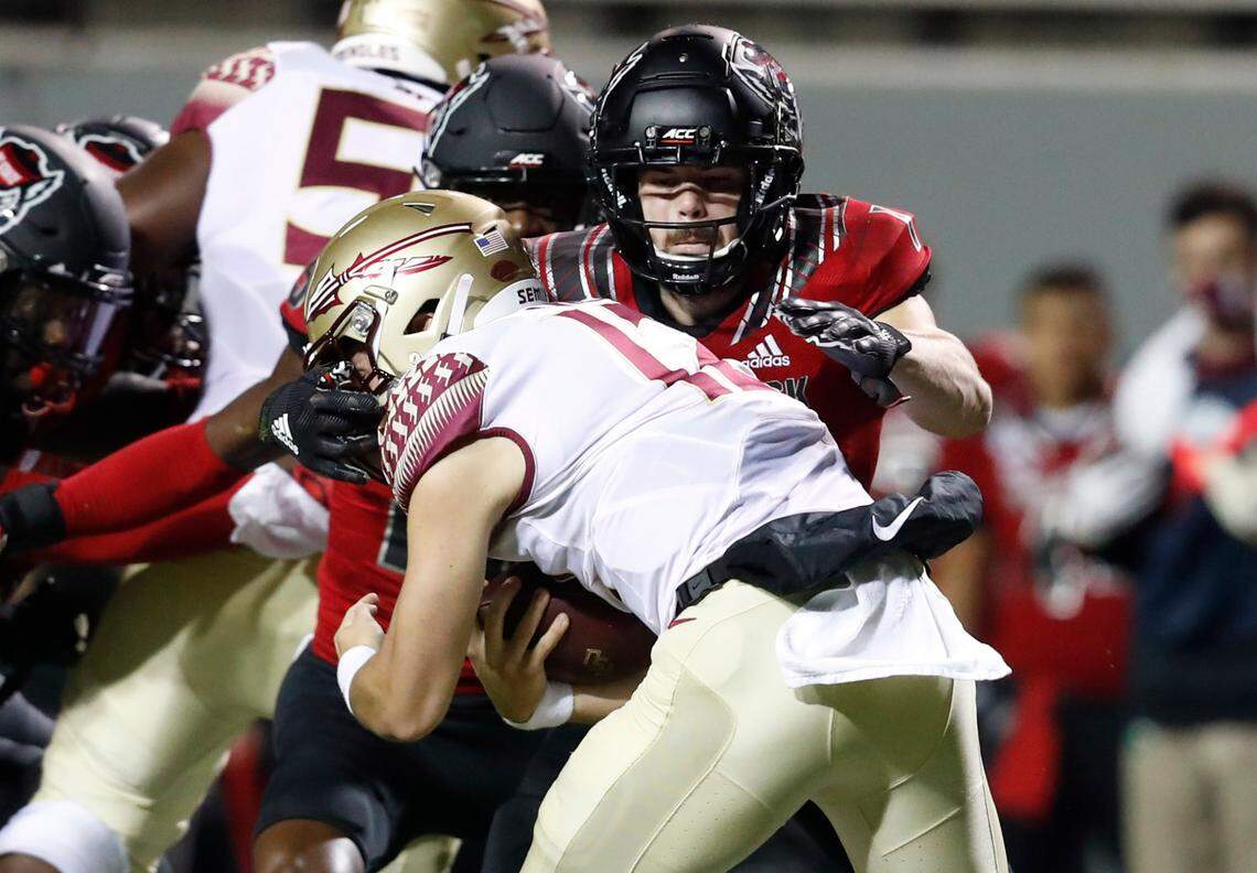 N.C. State linebacker Payton Wilson (11) tackles Florida State quarterback Chubba Purdy (12) during the first half of N.C. State’s game against Florida State at Carter-Finley Stadium in Raleigh, N.C., Saturday, Nov. 14, 2020.