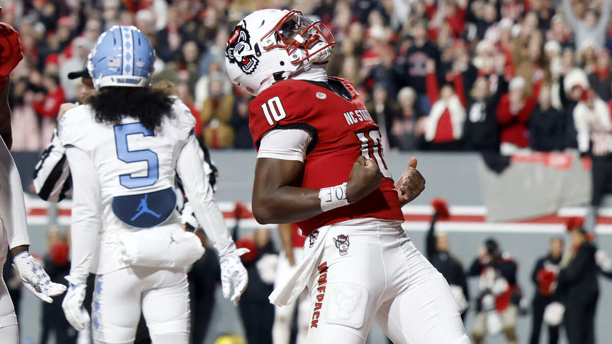 N.C. State quarterback Will Wilson (10) celebrates after scoring on a seven yard touchdown run during the first half of N.C. State’s game against UNC at Carter-Finley Stadium in Raleigh, N.C., Saturday, Nov. 29, 2025.