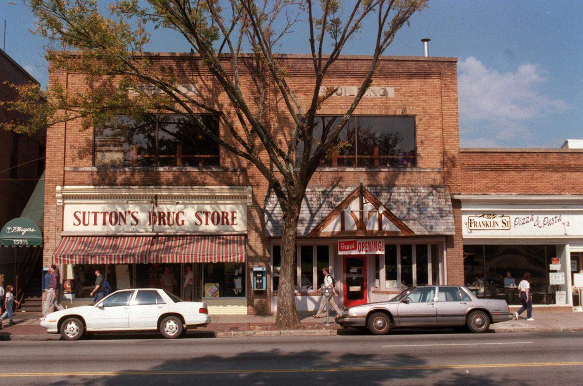 The storefront of the Strowd Building on Franklin St. across from the UNC-CH campus in 1996. Sutton’s Drug Store remains open after 100 years.