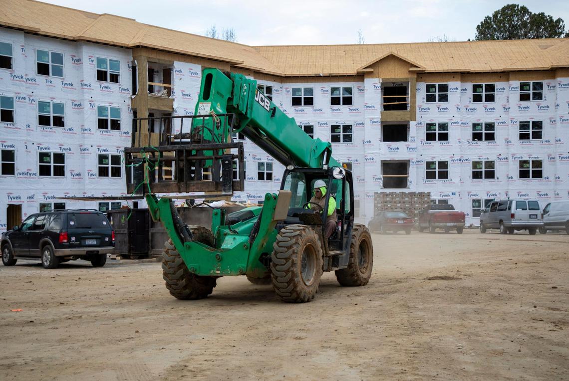 A forklift passes through the future site of Beacon Ridge, an affordable housing development providing 120 units for low-income families, developed by Gregg Warren during his 34-year tenure as president of DHIC, on Wednesday, Dec. 11, 2019, in Raleigh, NC. He plans to retire in the spring.