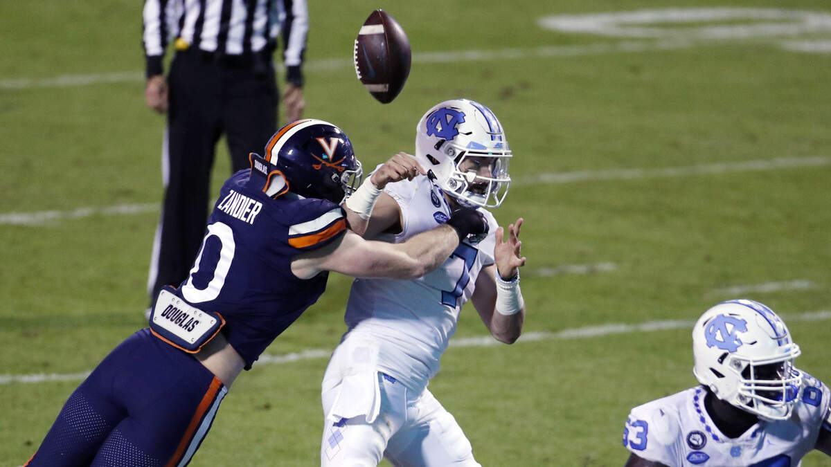 UNC quarterback Sam Howell fumbles as he his hit by Virginia linebacker Zane Zandler in second quarter action Saturday night, Oct. 31, 2020.
