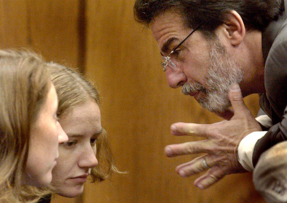 Michael Peterson defense attorney David Rudolf speaks with Margaret (at left) and Martha Ratliff during a break in the Michael Peterson murder trial Friday.