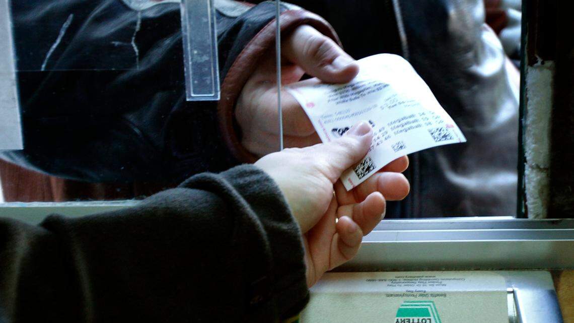 The man said he doesn’t usually play the lottery, but buys a raffle ticket every year. (AP Photo/Keith Srakocic)