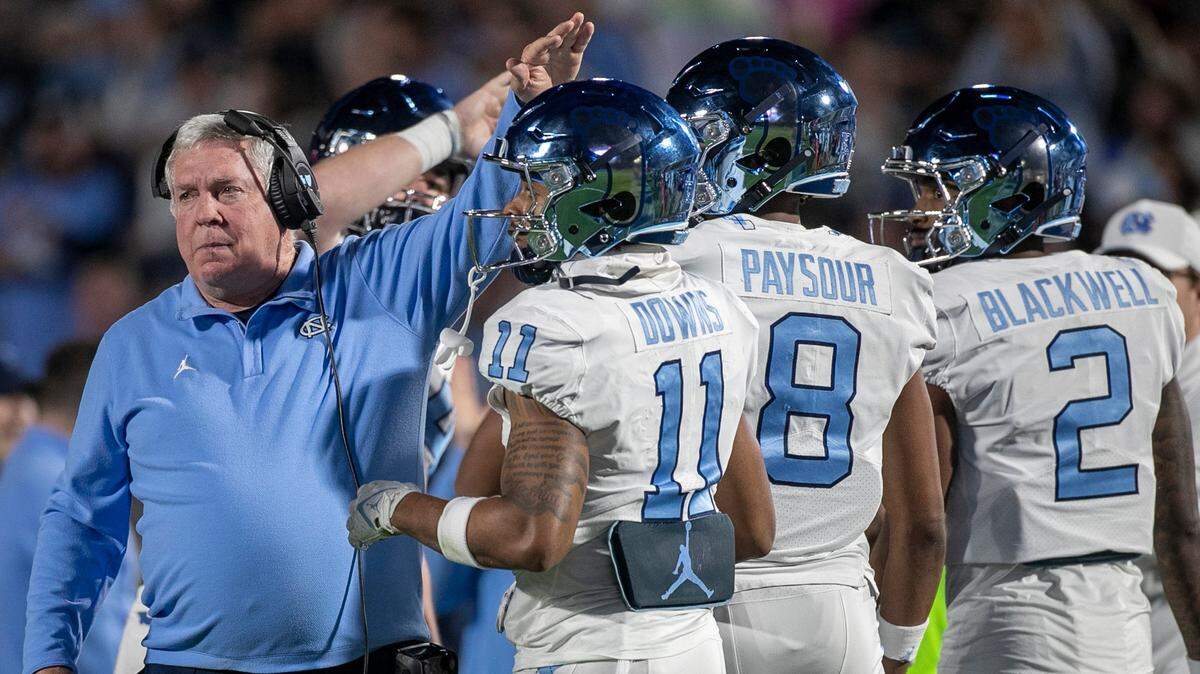 North Carolina coach Mack Brown gives Josh Downs (11) a pat on the head after the Tar Heels’ first touchdown drive on Saturday, October 15, 2022 at Wallace-Wade Stadium in Durham, N.C. Downs had nine catches for 126 yards in the Tar Heels’ victory.