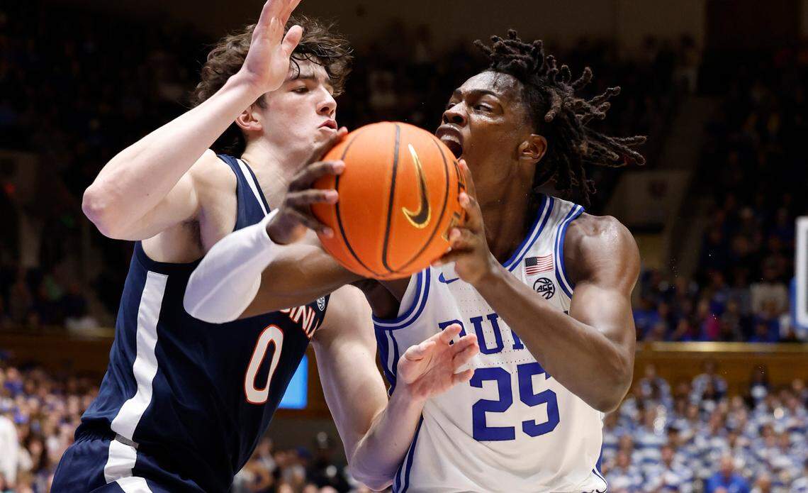 Duke’s Mark Mitchell (25) drives by Virginia’s Blake Buchanan (0) during the second half of Duke’s 73-48 victory over Virginia at Cameron Indoor Stadium in Durham, N.C., Saturday, March 2, 2024.