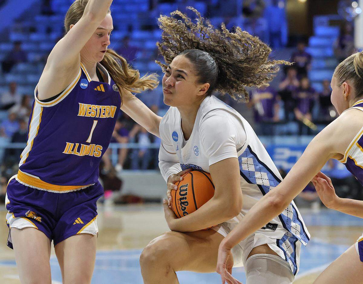 North Carolina’s Taliyah Henderson drives between Western Illinois’ Madison Davis and Mia Nicastro during the second half of the Tar Heels’ 82-51 first-round NCAA Tournament win on Friday, March 20, 2026, at Carmichael Arena in Chapel Hill, N.C.