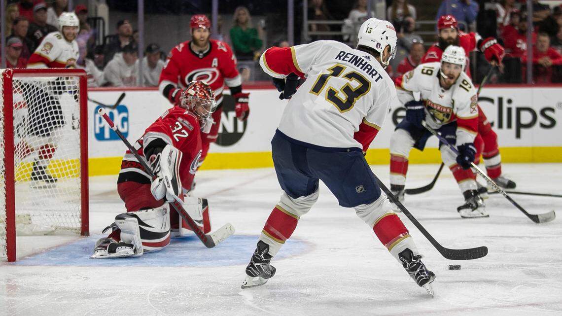 The Florida Panthers Sam Reinhart (13) passes to an open Matthew Tkachuk (19) for the game winning goal in overtime to secure a 2-1 victory over the Carolina Hurricanes in Game 2 of the Eastern Conference Finals on Saturday, May 20, 2023 at PNC Arena in Raleigh, N.C. The Hurricanes Jaccob Slavin (74) and Brent Burns (8) were tangled up on the play and were unable to defend Tkachuk.
