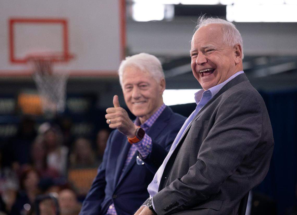 Former President Bill Clinton and Democratic vice presidential candidate Tim Walz share a laugh during a rally at the Community Family Life & Recreation Center at Lyon Park on Thursday, Oct. 17, 2024, in Durham, N.C.