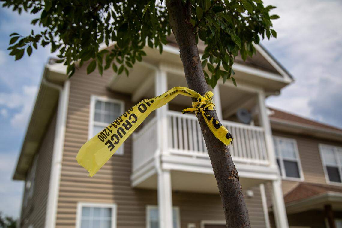 Crime tape is tied to a tree outside an apartment duplex on McNeil Lane in Durham Tuesday, July 16, 2019. An 8-year-old girl was shot and an 11-year-old boy injured early Monday morning after bullets were fired into their home early Monday morning on McNeil Lane in Durham.